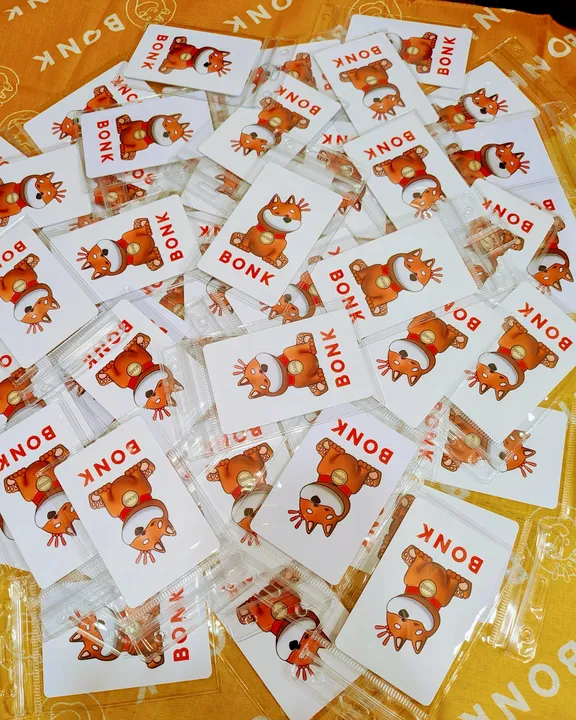A pile of NFC cards in clear sleeves on an orange table